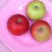 Discovery apples on pink plate